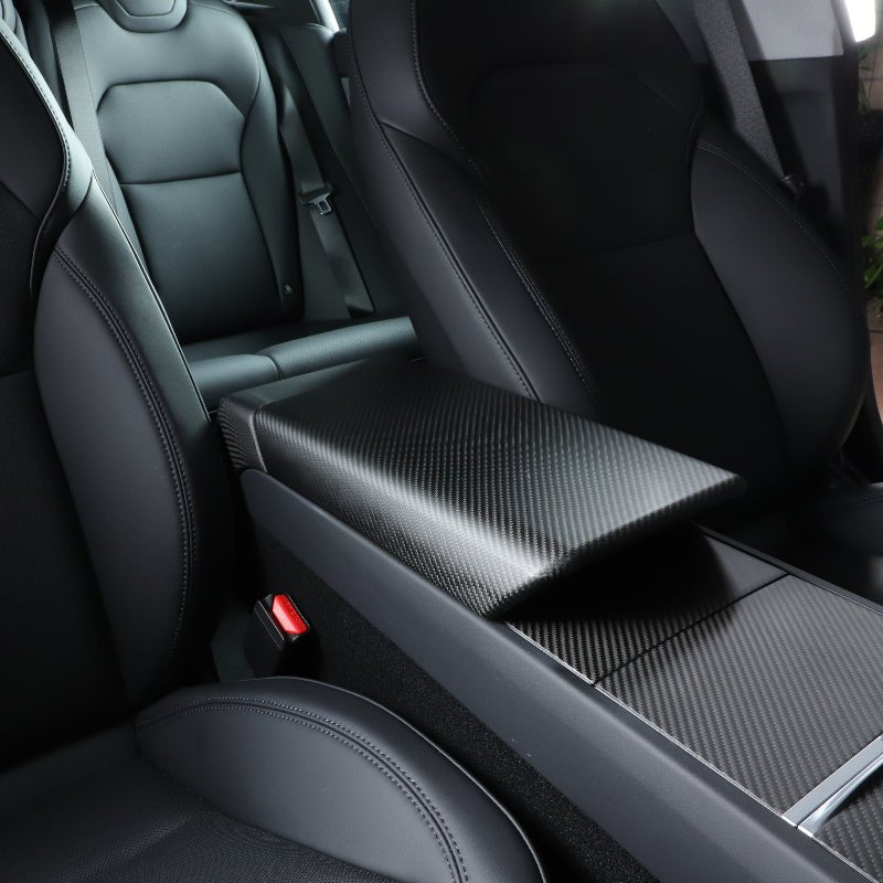Matte real carbon fiber armrest cover installed in a compatible Tesla interior