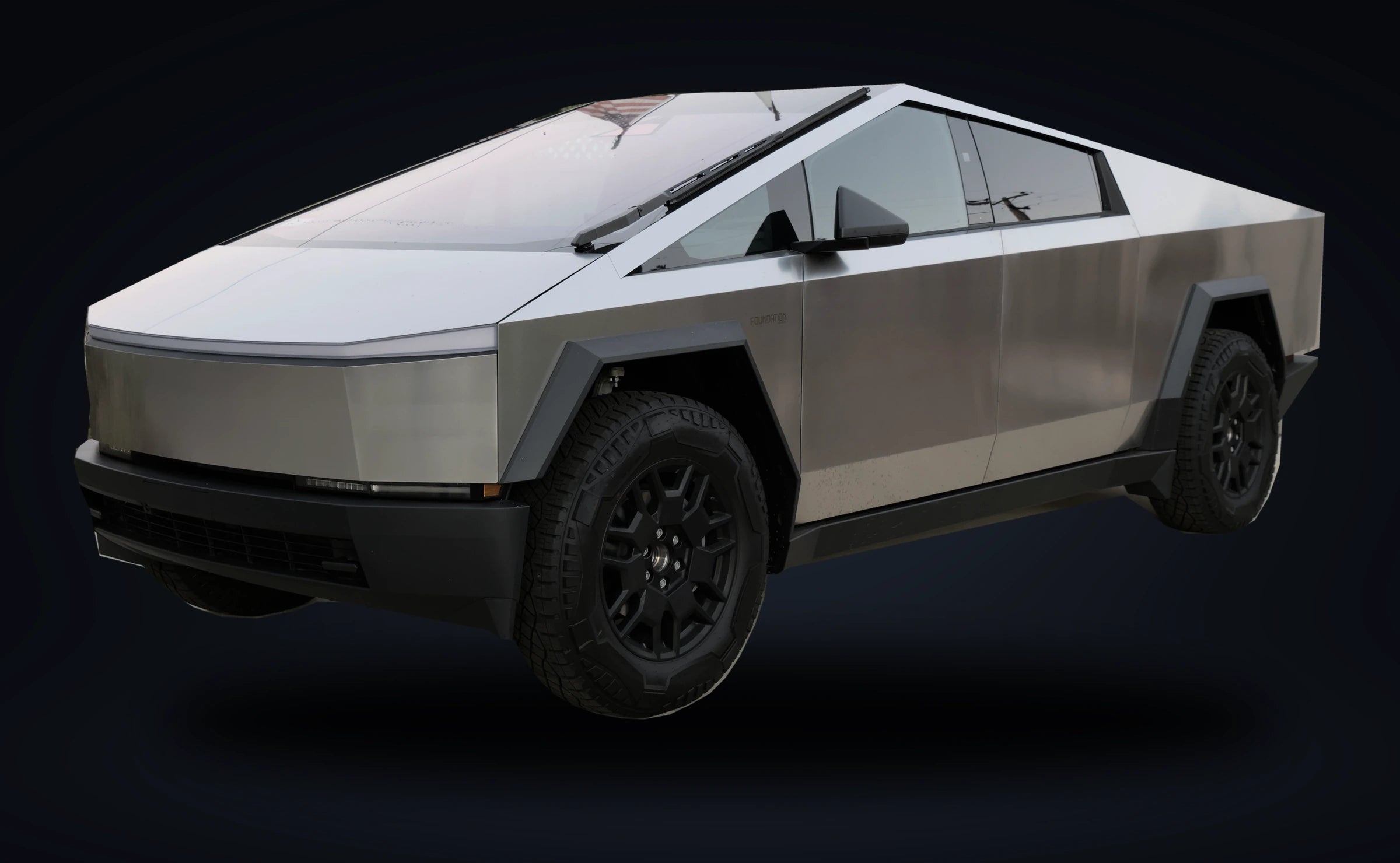 Silver Cybertruck isolated against a dark studio-style background, photo composite