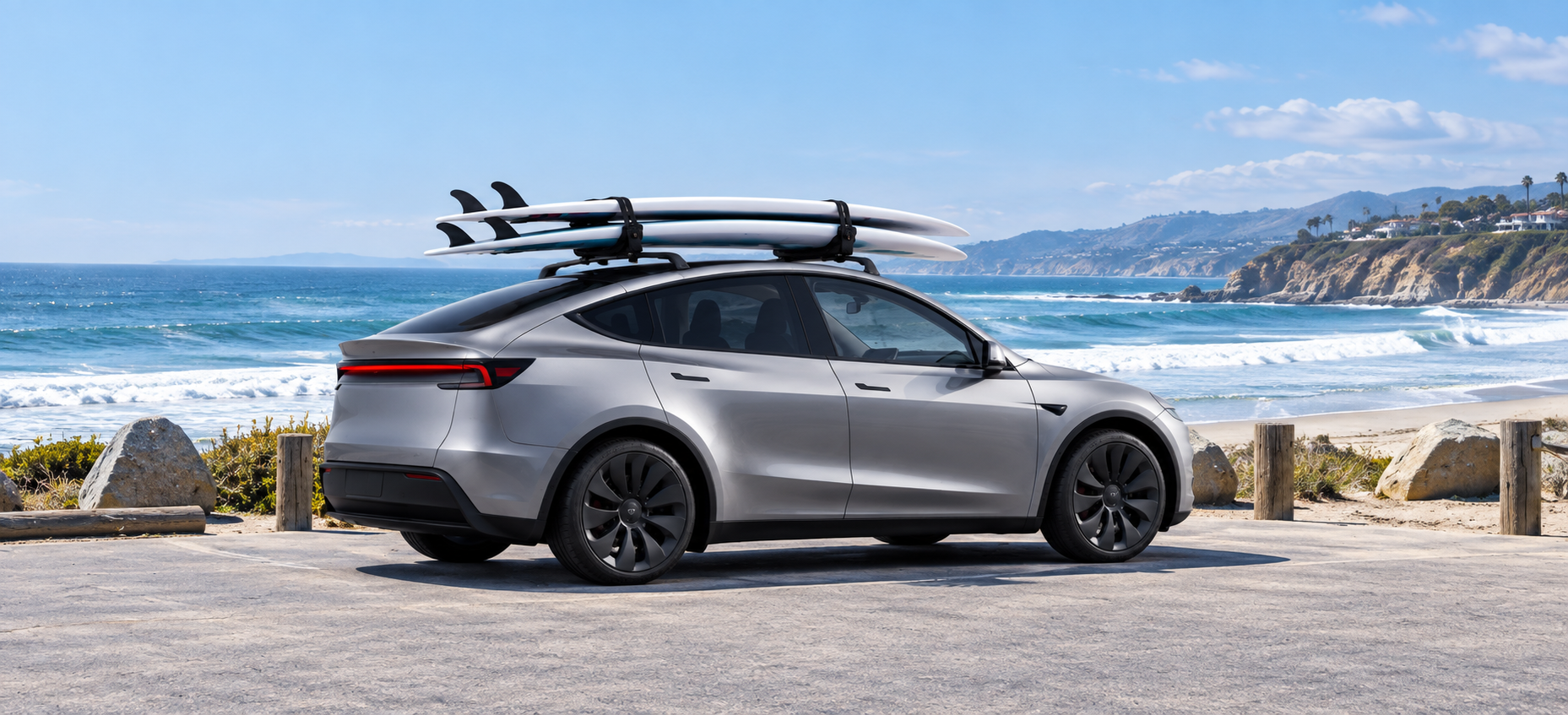 Tesla with TESERY roof rack carrying surfboards at the beach