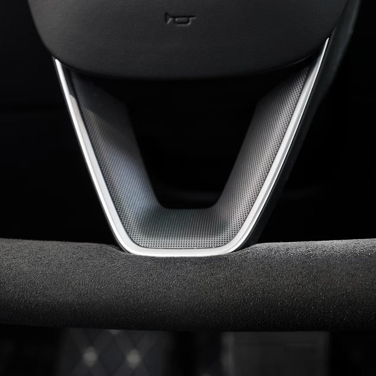 Alcantara yoke steering wheel installed in a Tesla cabin